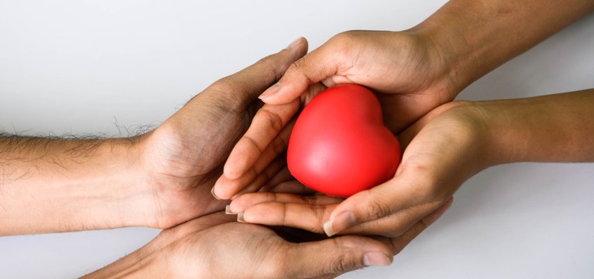 Helping hand of heart donor for patient in heart disease. Man give red heart to woman as couple. People lifestyle and couple romance. Healthcare and hospital medical concept. Symbolic of Valentine day