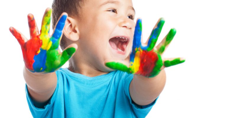 cheerful child with painted hands on white background