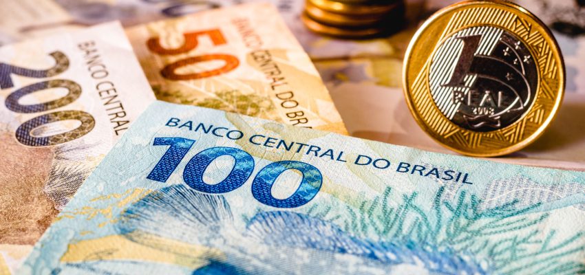 In this photo illustration being displayed fifty, one hundred and two hundred reais bills and a one reais coin highlighted. The Real is the current money in Brazil